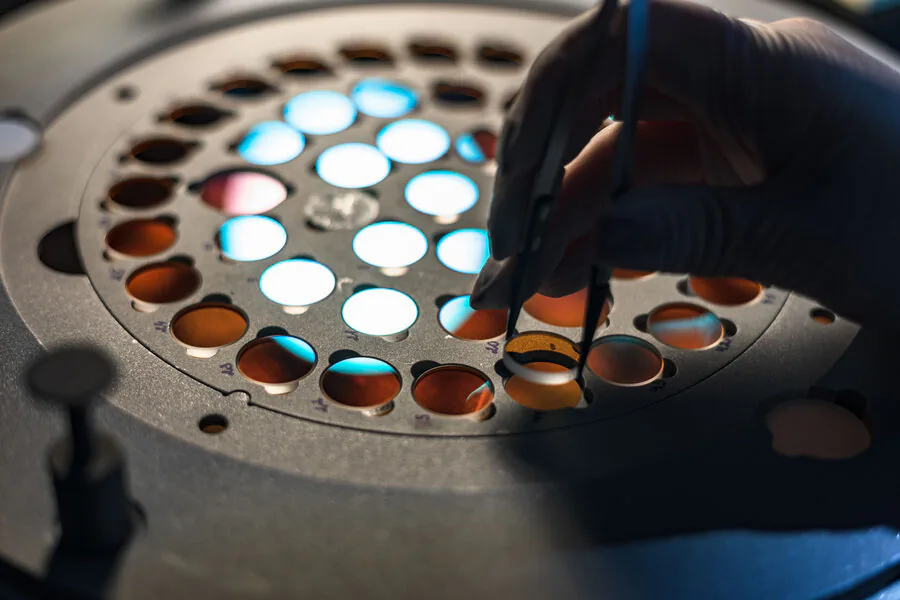 Operator loading coated optics onto a deposition holder